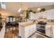 Open kitchen with white cabinetry, bright countertops, and stainless steel appliances at 9689 W Chatfield Ave # H, Littleton, CO 80128