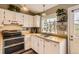 Bright kitchen with white cabinets, butcher block counters, and stainless steel appliances at 9689 W Chatfield Ave # H, Littleton, CO 80128