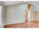 Spacious room with hardwood floors, natural light, and neutral wall paint at 9689 W Chatfield Ave # H, Littleton, CO 80128