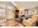 Bright living room with vaulted ceilings, skylight, a fireplace, and a cozy sectional sofa at 9689 W Chatfield Ave # H, Littleton, CO 80128