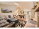Open-concept living room with hardwood floors, a skylight, and seamless flow to dining area at 9689 W Chatfield Ave # H, Littleton, CO 80128