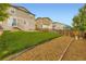 View of the backyard featuring a mulched area and lush green grass with a fence at 1998 Coach House Loop, Castle Rock, CO 80109