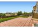 Fenced backyard with grass and brick tile area perfect for outdoor activities at 1998 Coach House Loop, Castle Rock, CO 80109