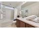 Bright bathroom featuring a shower-tub combo and vanity with a large mirror at 1998 Coach House Loop, Castle Rock, CO 80109