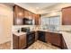 Functional kitchen with dark appliances, granite countertops, ample cabinet space, and natural lighting at 1998 Coach House Loop, Castle Rock, CO 80109