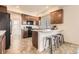 Modern kitchen featuring brown cabinets, granite countertops, and a black refrigerator at 1998 Coach House Loop, Castle Rock, CO 80109