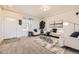 Bright living room with white furniture, modern decor, large windows, and neutral carpet at 1998 Coach House Loop, Castle Rock, CO 80109