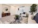 Inviting living room with a white chair, modern decor, large windows, and neutral carpet at 1998 Coach House Loop, Castle Rock, CO 80109