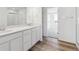 Modern bathroom with double sink vanity and stylish wood look flooring at 270 Lark Sparrow Way, Bennett, CO 80102