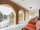 Brick balcony with arched openings and wicker furniture at 757 N Bluff Dr, Franktown, CO 80116