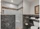 Bathroom with walk-in shower, marble tile, and a toilet at 757 N Bluff Dr, Franktown, CO 80116