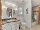 Bathroom with granite vanity, oval mirror, and a tub shower combo at 757 N Bluff Dr, Franktown, CO 80116