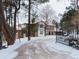 House exterior with gated entry and snow-covered driveway at 757 N Bluff Dr, Franktown, CO 80116