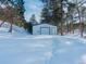 Detached garage with double doors in snowy setting at 757 N Bluff Dr, Franktown, CO 80116