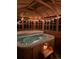 Relax in this covered hot tub, complete with string lights and wooden accents at 757 N Bluff Dr, Franktown, CO 80116