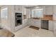 Modern kitchen with white cabinets and stainless steel appliances at 757 N Bluff Dr, Franktown, CO 80116