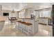 Modern kitchen with white cabinets, granite counters, and island at 757 N Bluff Dr, Franktown, CO 80116