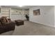 Comfortable living room featuring a plush sofa, ottoman, built-in shelves, and a cozy atmosphere at 757 N Bluff Dr, Franktown, CO 80116