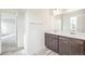 Double vanity bathroom with dark brown cabinets and a shower at 13432 E 110Th Way, Commerce City, CO 80022