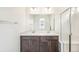 Bathroom featuring double sinks, a large mirror, and shower at 13432 E 110Th Way, Commerce City, CO 80022