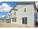Two-story house with beige siding, large windows, and a sliding glass door at 13432 E 110Th Way, Commerce City, CO 80022