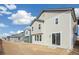 Two-story house with beige siding, large windows, and a sliding glass door at 13432 E 110Th Way, Commerce City, CO 80022