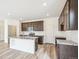 Modern kitchen featuring granite island and dark wood cabinets at 13432 E 110Th Way, Commerce City, CO 80022