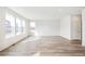 Large living room with hardwood floors and multiple windows at 13432 E 110Th Way, Commerce City, CO 80022