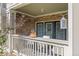 Private balcony with stone accents, covered seating area, and sliding glass doors at 4385 S Balsam St # 10-103, Littleton, CO 80123