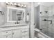 Bathroom features white vanity, marble countertop, and glass-enclosed shower at 4385 S Balsam St # 10-103, Littleton, CO 80123
