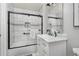 This bathroom features marble-look tile, decorative mirrors, and matte black hardware and fixtures at 4385 S Balsam St # 10-103, Littleton, CO 80123