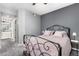 Bedroom featuring an iron bed frame, neutral walls, and an en suite bathroom view for added convenience at 4385 S Balsam St # 10-103, Littleton, CO 80123