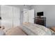 Bedroom features a large closet, gray walls, and patterned bedding in neutral tones at 4385 S Balsam St # 10-103, Littleton, CO 80123