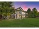 Charming two-story home with a well-manicured lawn, inviting porch, and scenic twilight sky at 4385 S Balsam St # 10-103, Littleton, CO 80123