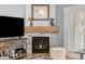 Living room fireplace with stone surround, wood mantle, and accent decor, creating a cozy ambiance at 4385 S Balsam St # 10-103, Littleton, CO 80123