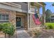 Inviting front entrance adorned with stone accents, decorative wreath, and an American flag, adding charm at 4385 S Balsam St # 10-103, Littleton, CO 80123