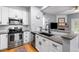 Updated kitchen featuring sleek stainless steel appliances, granite counters, and a modern backsplash design at 4385 S Balsam St # 10-103, Littleton, CO 80123