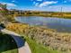 Scenic view of a serene lake surrounded by lush greenery and a walking path at 4385 S Balsam St # 10-103, Littleton, CO 80123