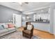 Open-concept living area with hardwood floors, comfortable seating, and a kitchen pass-through for easy entertaining at 4385 S Balsam St # 10-103, Littleton, CO 80123