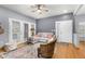 Bright living room featuring a comfortable sectional, plush armchair, and access to outdoor patio via French doors at 4385 S Balsam St # 10-103, Littleton, CO 80123