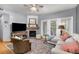 Cozy living room with a fireplace, ceiling fan, and a door to the outside deck at 4385 S Balsam St # 10-103, Littleton, CO 80123