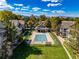 Aerial view of community pool surrounded by lush green lawns and residential buildings at 4385 S Balsam St # 10-103, Littleton, CO 80123