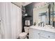 Well-lit bathroom with modern fixtures, white vanity, and shower with curtain at 2900 Purcell St # F1, Brighton, CO 80601