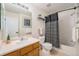 Bathroom with a shower and bath, toilet and vanity with basin and faucet at 2900 Purcell St # F1, Brighton, CO 80601