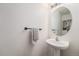 Bathroom features a round mirror, pedestal sink, and updated hardware at 2900 Purcell St # F1, Brighton, CO 80601