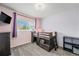 Charming bedroom featuring a unique loft bed, carpet and soft lilac wall color at 2900 Purcell St # F1, Brighton, CO 80601