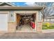 Functional garage space with ample storage, workbench, and a motorcycle at 2900 Purcell St # F1, Brighton, CO 80601