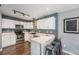 Modern kitchen with white cabinets, stainless steel appliances, and breakfast bar at 2900 Purcell St # F1, Brighton, CO 80601
