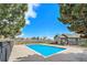 Community pool area with a bright blue pool and a shared clubhouse building at 2900 Purcell St # F1, Brighton, CO 80601