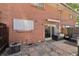 Backyard featuring a brick wall, paved stones, an AC unit and patio furniture at 12455 W Alameda Dr, Lakewood, CO 80228